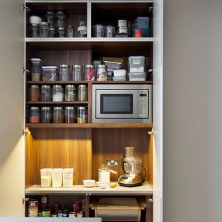 kitchen room with wooden shelves and microwave oven