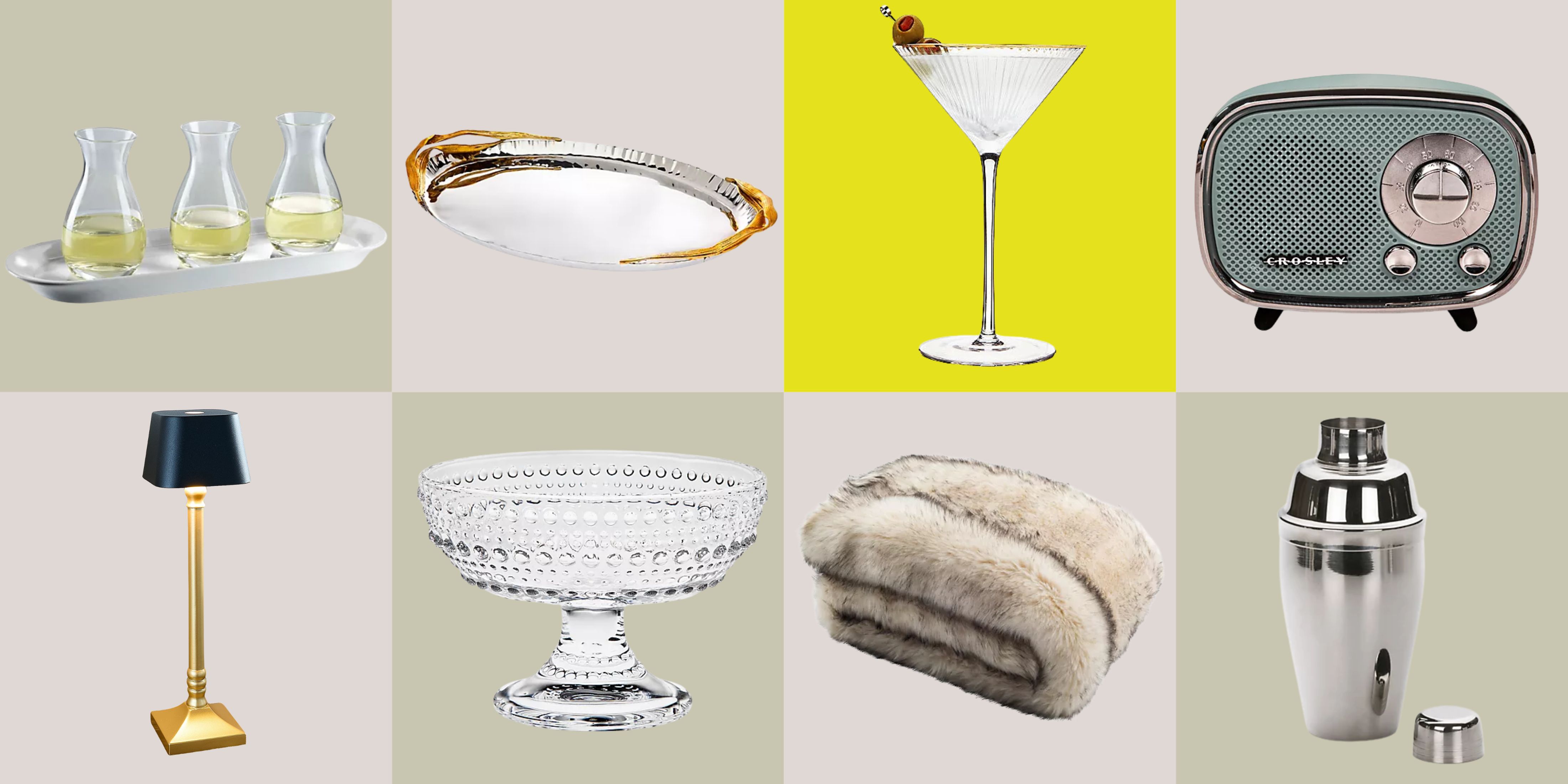Ingredients for an elevated bed rot, including a martini glass, cordless lamp, faux fur throw blanket, and silver tray, pictured against a colorful checkered background