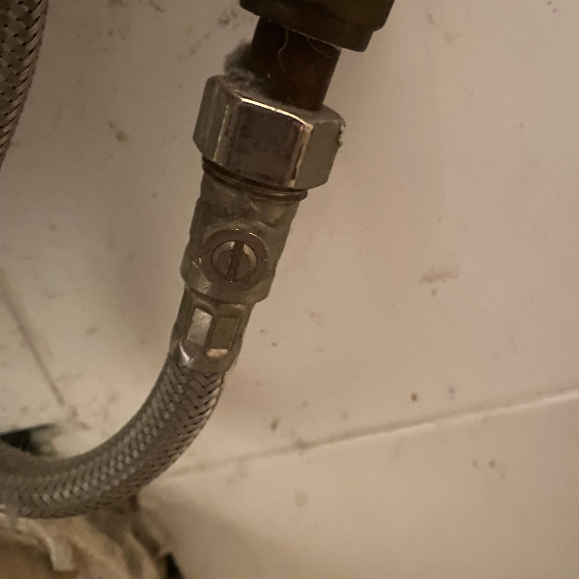 Close up of the toilet isolation valve with the water on