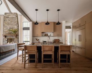 modern open-plan kitchen with wooden built-in cabinets, wood flooring, white walls and kitchen island