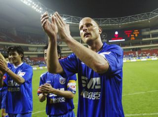 Carsten Jancker applauds the fans after his debut for Shanghai Shenhua in May 2006.