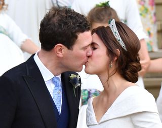 Jack Brooksbank and Princess Eugenie kiss as they leave St George's Chapel
