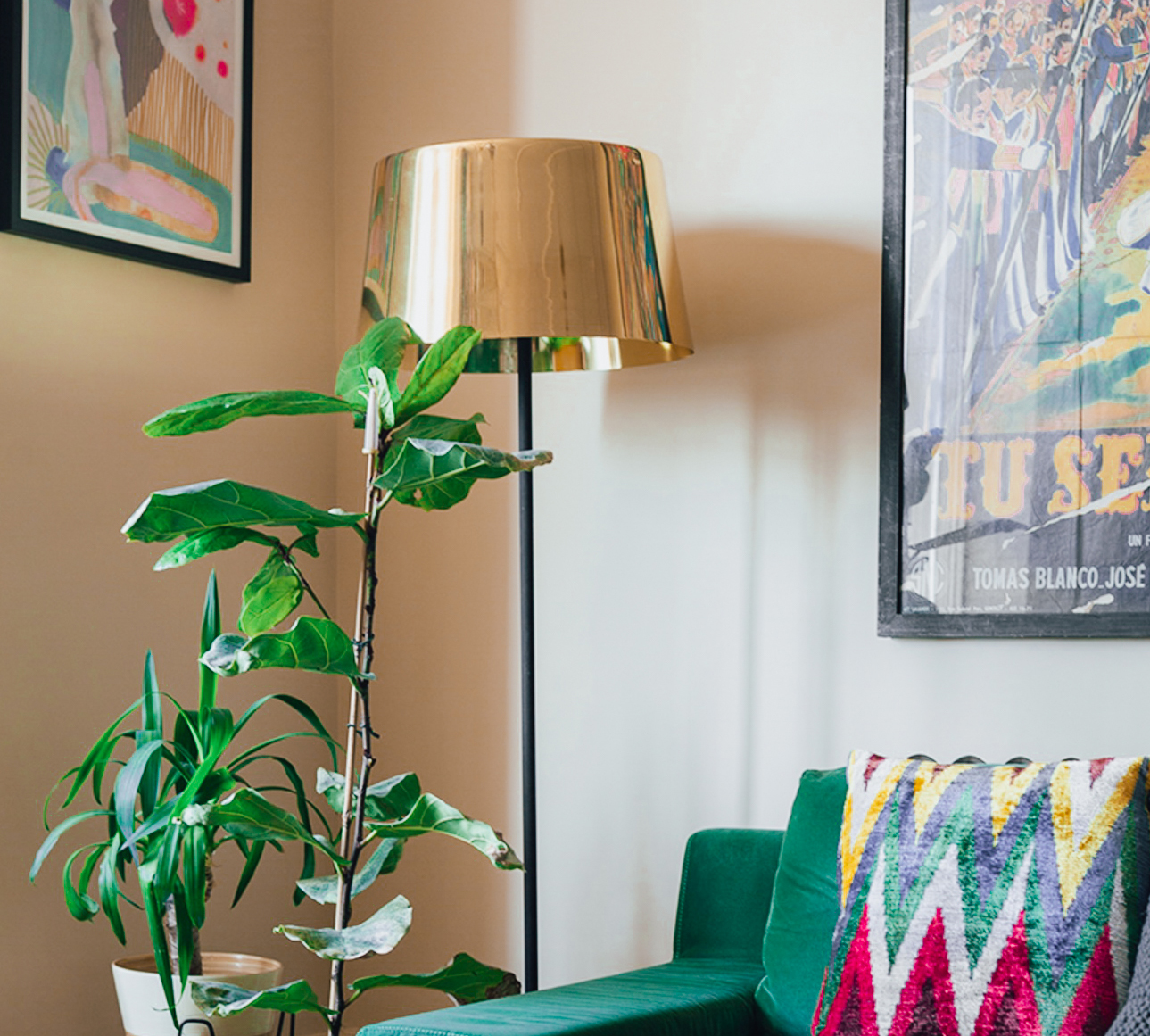gold floor lamp next to a green sofa