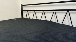 Close up of the black Eight Sleep Pod 4 on metal bed frame