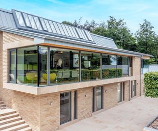 A contemporary brick-clad Passivhaus in Yorkshire with extensive glazing, from Internorm, overlooking the garden