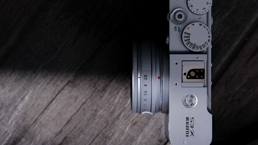 The Fujifilm XF 23mm f/2.8 R WR on a gray wood-like surface