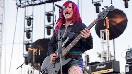 Jennifer Finch of L7 playing her 'Bastard' or ‘Ghost’ bass onstage in 2015