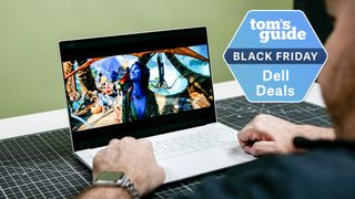 Person using Dell 14 Premium with Tom's Guide Black Friday Dell Deals badge