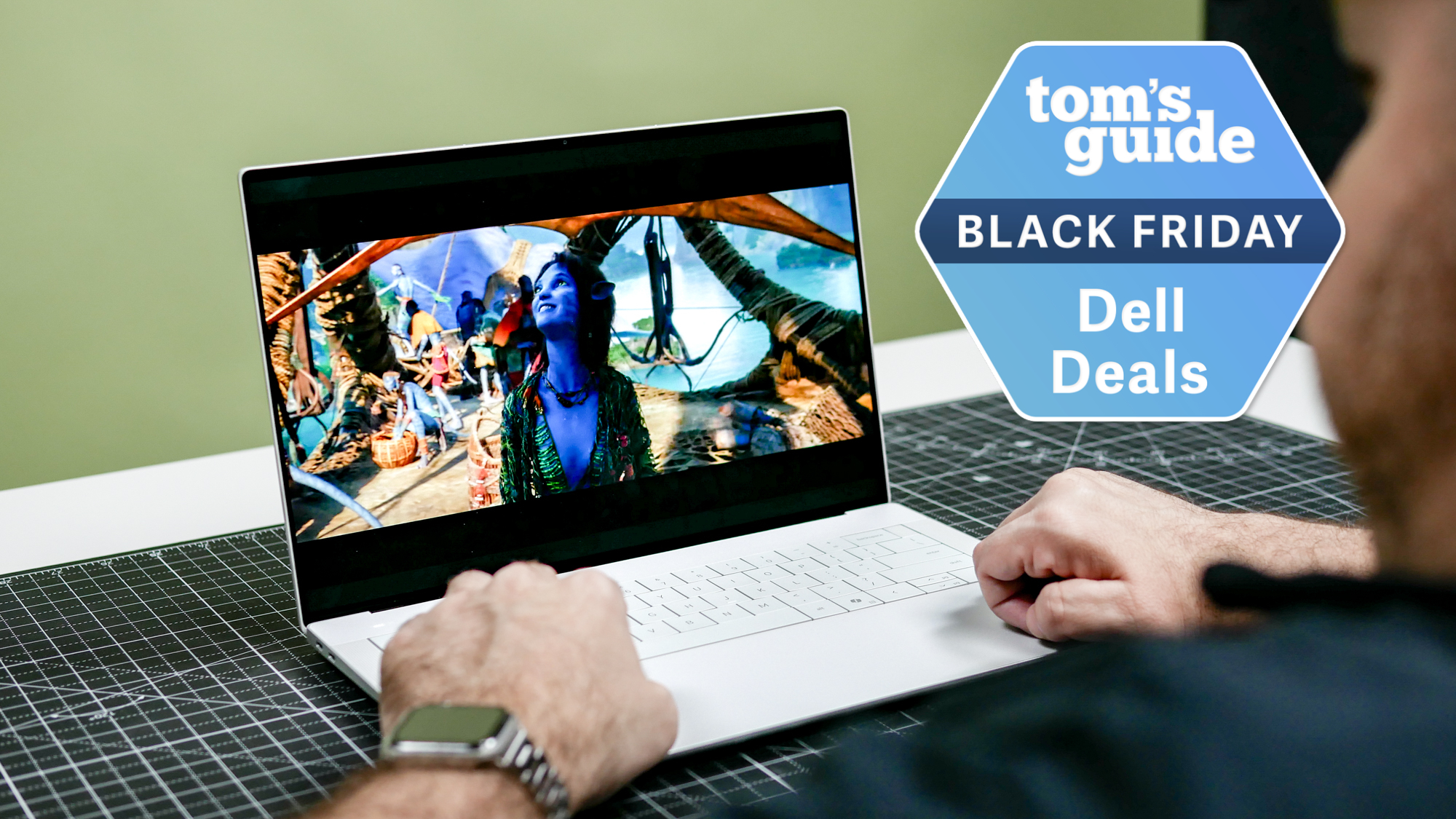 Person using Dell 14 Premium with Tom's Guide Black Friday Dell Deals badge