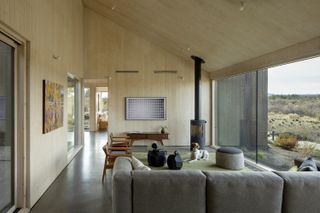 modern farmhouse living room with pine clad walls and freestanding fire