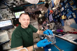 NASA astronaut Nick Hague using the miniPCR hardware to explore how space radiation damages DNA.