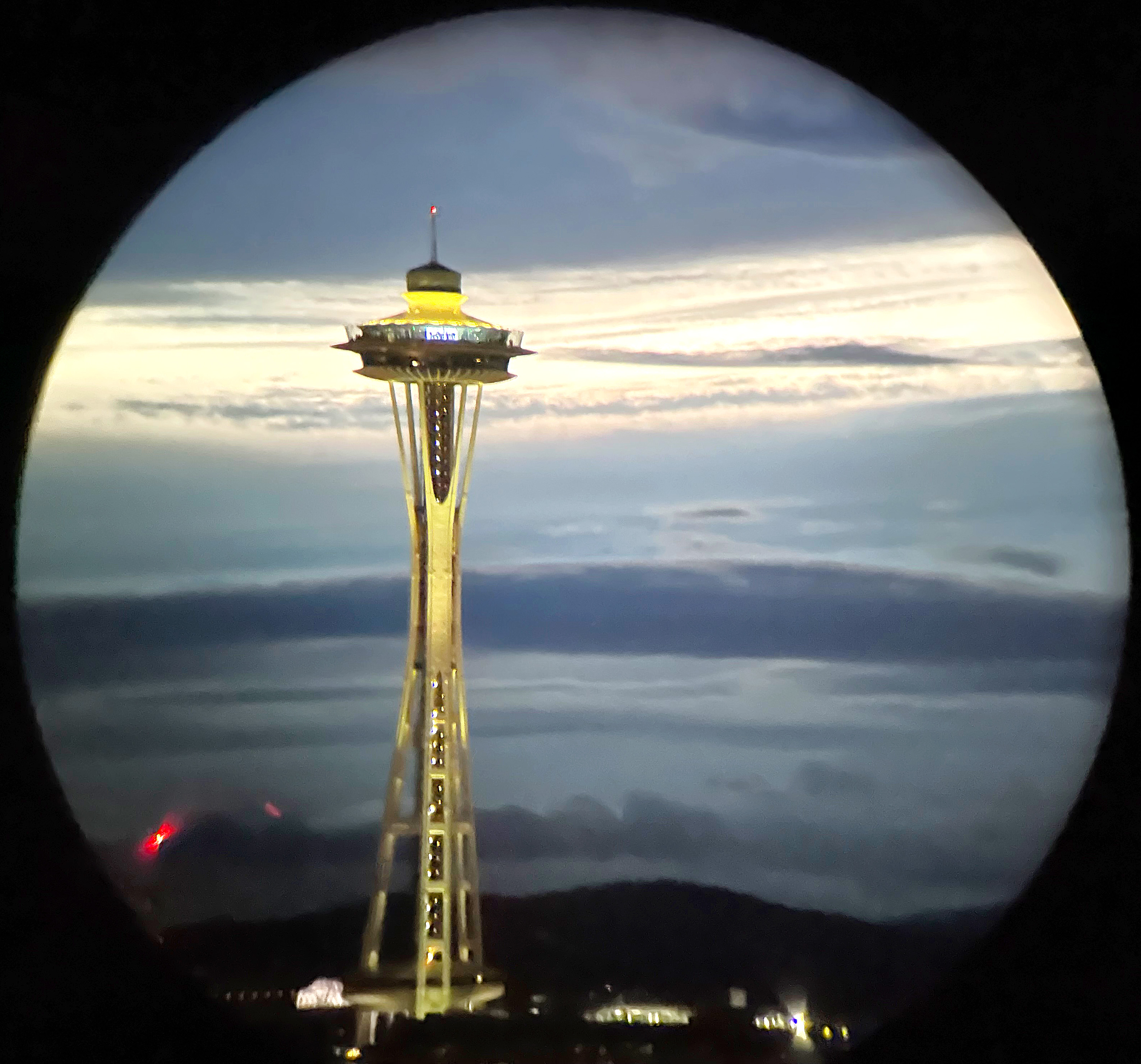 A photo of the Space Needle in Seattle at night, shot through a pair of Nocs.