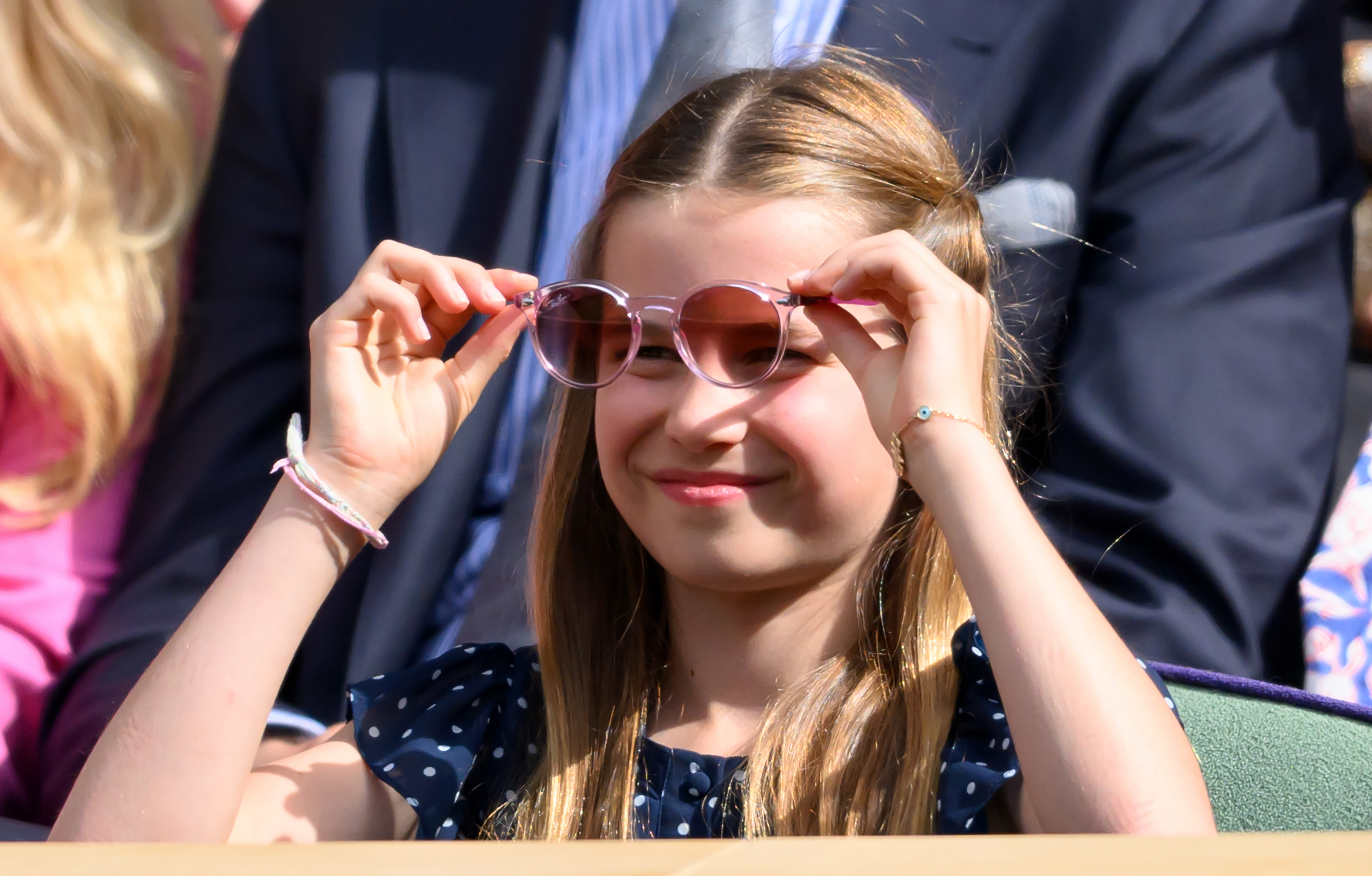 Princess Charlotte lifting her sunglasses at Wimbledon