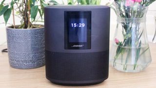 Bose Smart Speaker 500 on table with flowers and plant