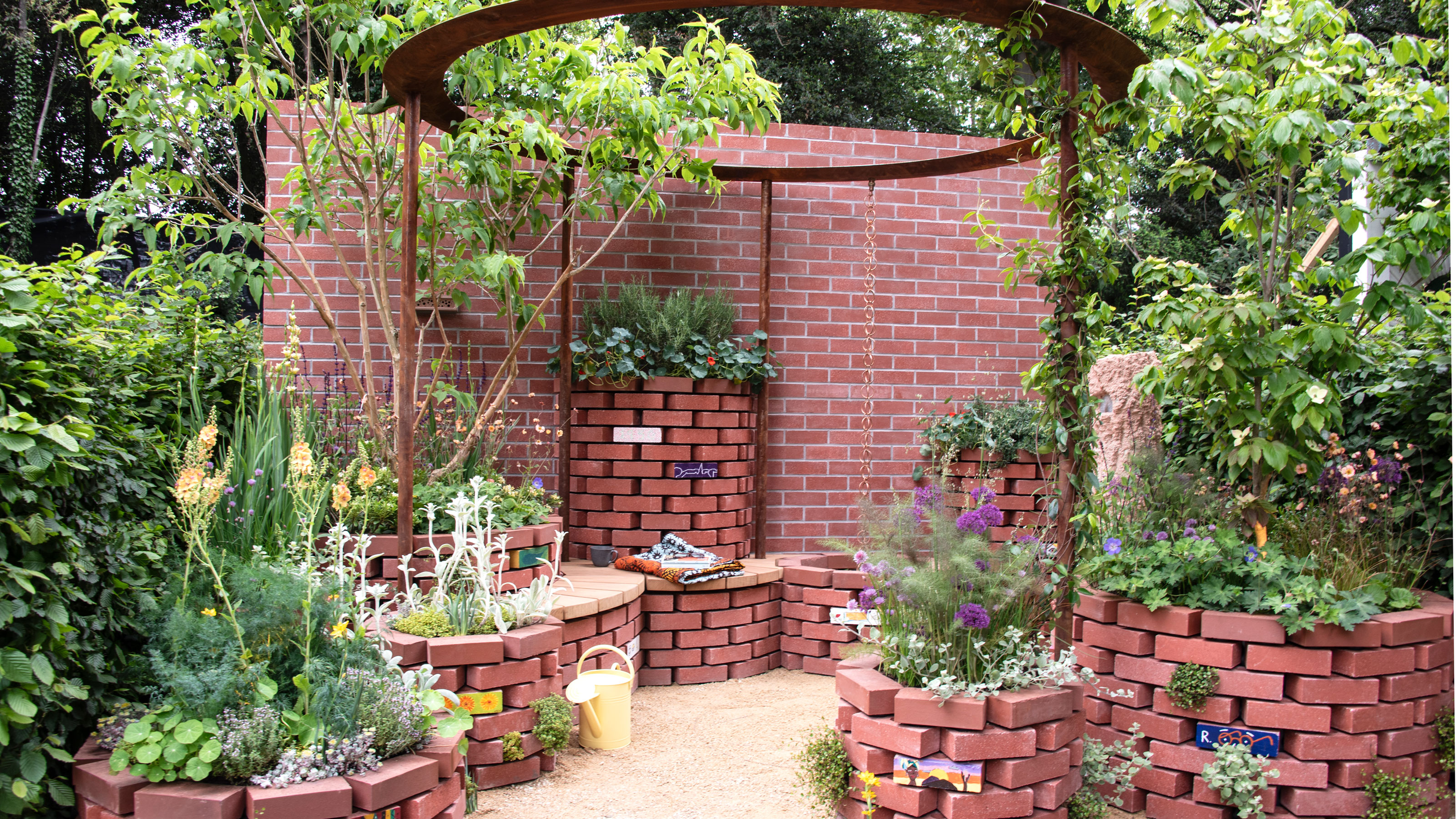 Brick wall with rain chain hanging from metal structure