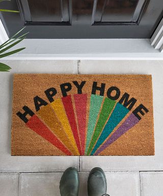 black door with doormat and shoes