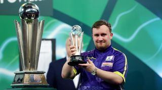 LONDON, ENGLAND - JANUARY 03: Runner-up Luke Littler of England celebrates with the runner-up trophy after the 2023/24 Paddy Power World Darts Championship Final between Luke Littler of England and Luke Humphries of England on Day Sixteen of the 2023/24 Paddy Power World Darts Championship at Alexandra Palace on January 03, 2024 in London, England. (Photo by Tom Dulat/Getty Images)