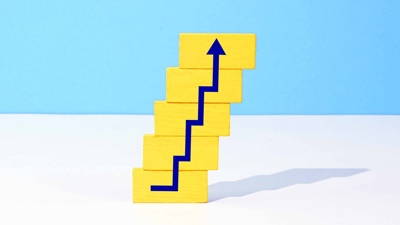 stacked yellow blocks with blue arrow stair-stepping higher