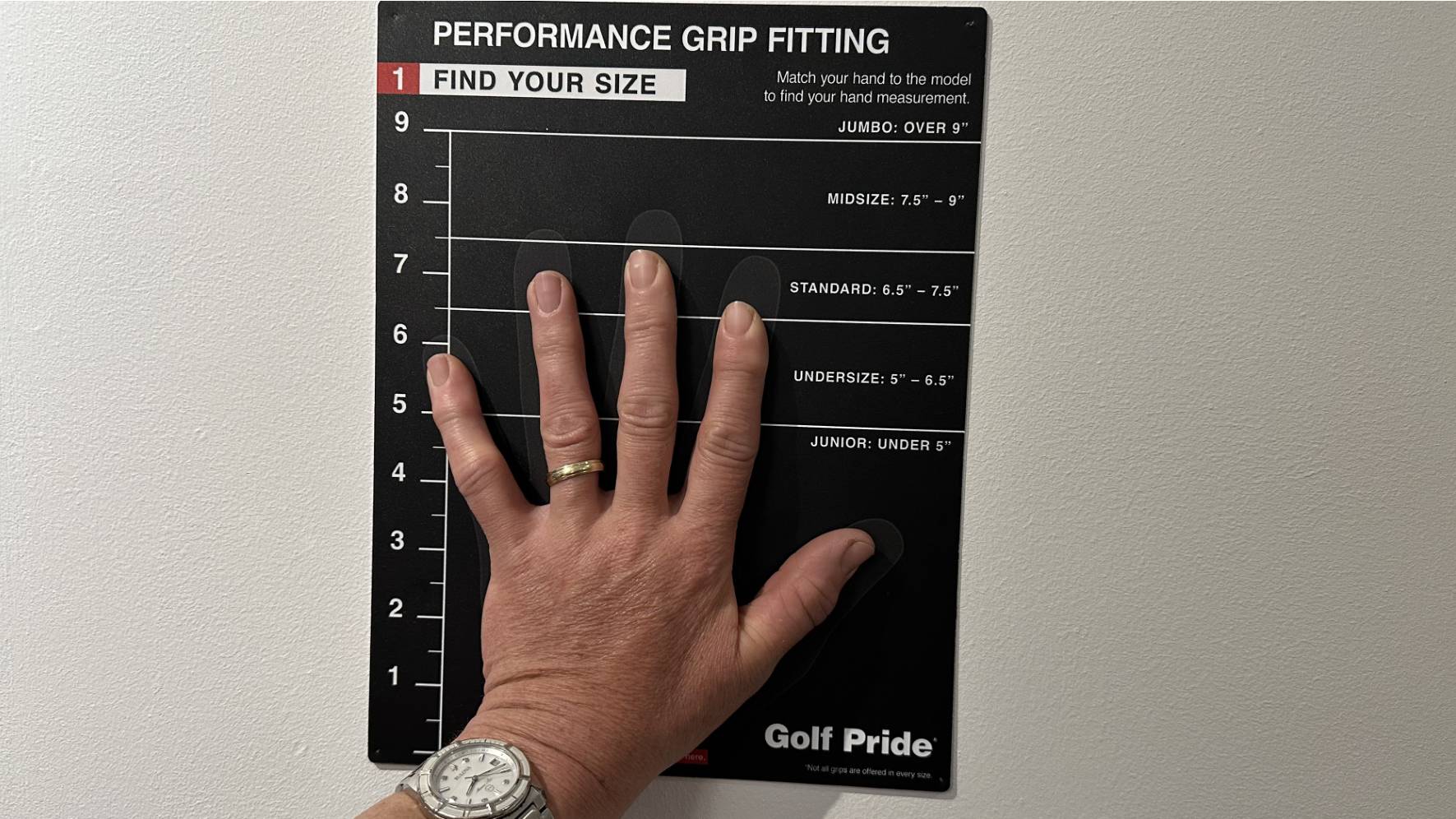 Female golfer with hand on grip fitting chart