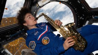 Astronaut Jessica Meir playing the saxophone on the ISS.