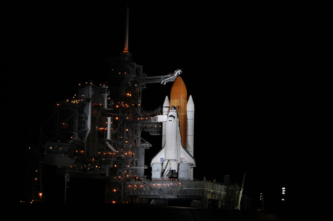 Shuttle and souvenirs at space station (STS-116 Official Flight Kit)