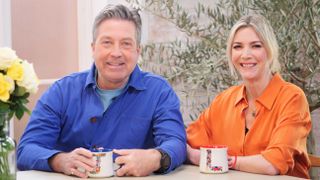 John & Lisa sitting side-by-side with cups of tea for John & Lisa's Weekend Kitchen series 8