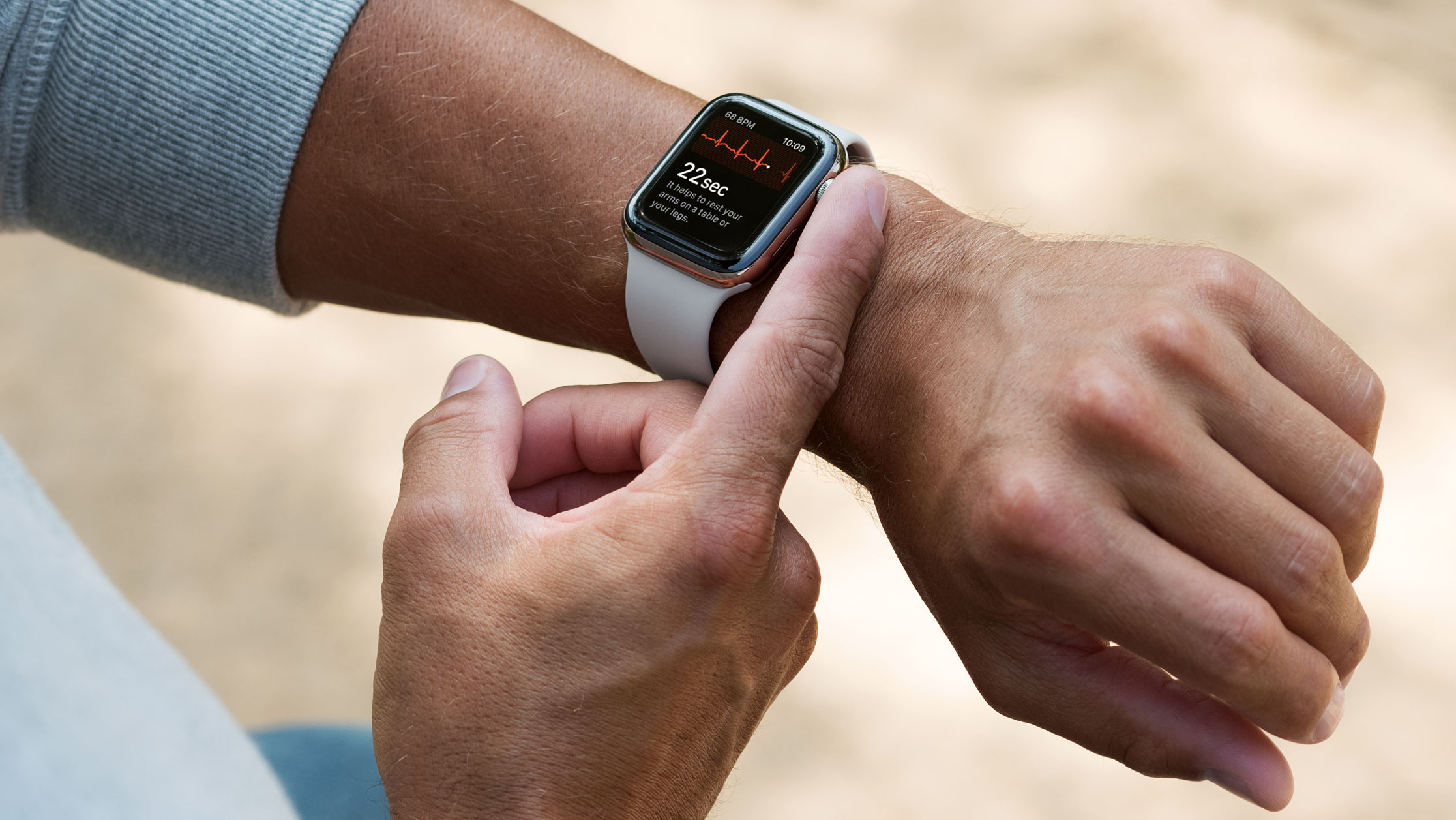 Person wearing Apple Watch, using its ECG app