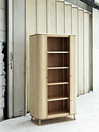 The circular cabinet mimics the outline of the agricultural machinery and has slatted tambour doors