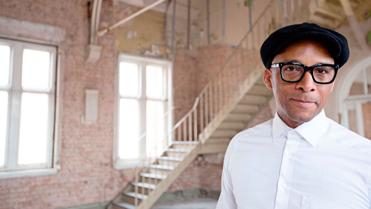 Jay Blades standing in a warehouse