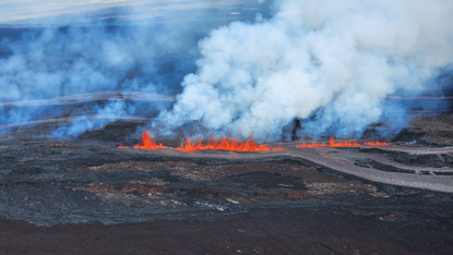 Lava erupts and spreads from Mauna Lao