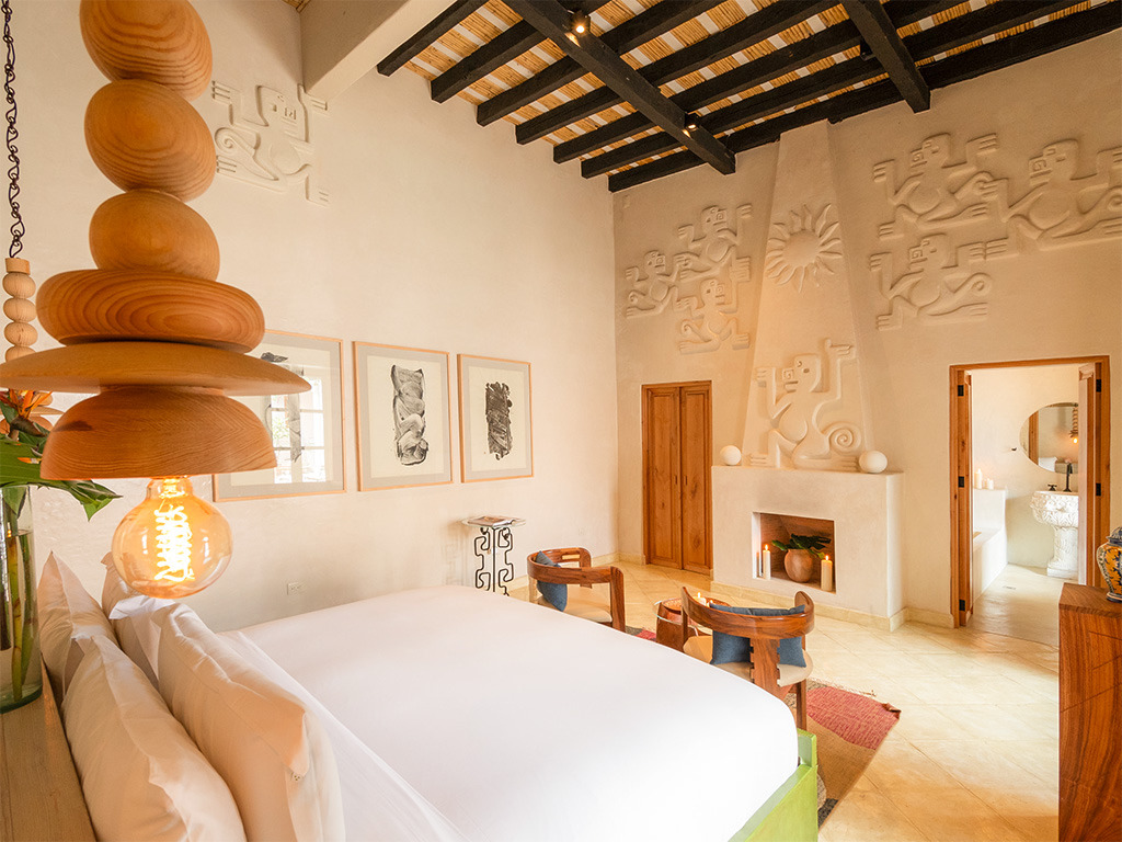 A room at La Valise San Miguel with Aztec monkeys on the wall