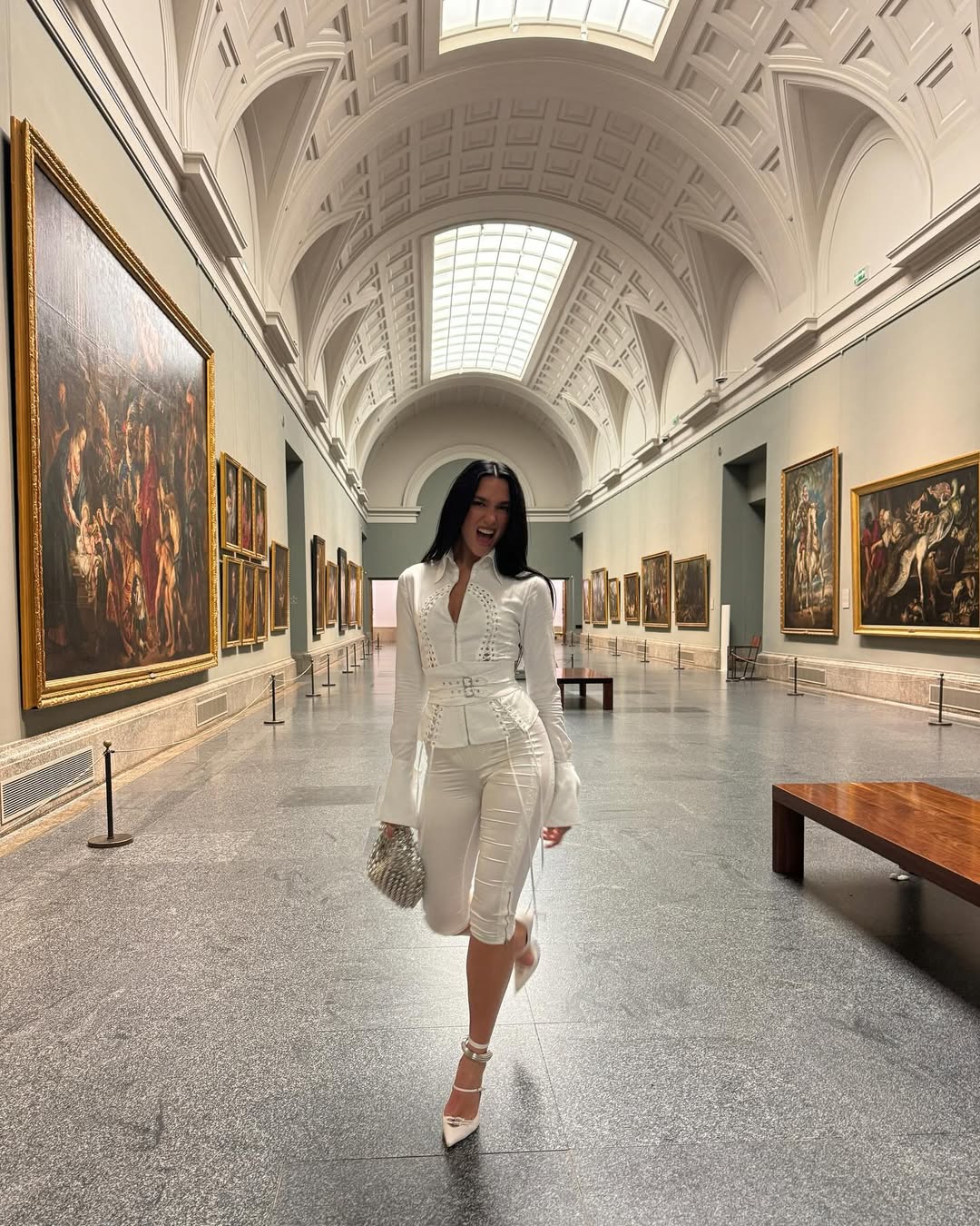 Dua Lipa in the Prado museum wearing a white Dilara set