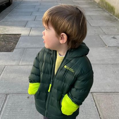 Princess Eugenie's son Ernest wearing a green coat 