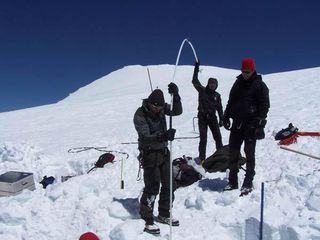 Researchers use tools to try to figure out the mass balance of the ice field.