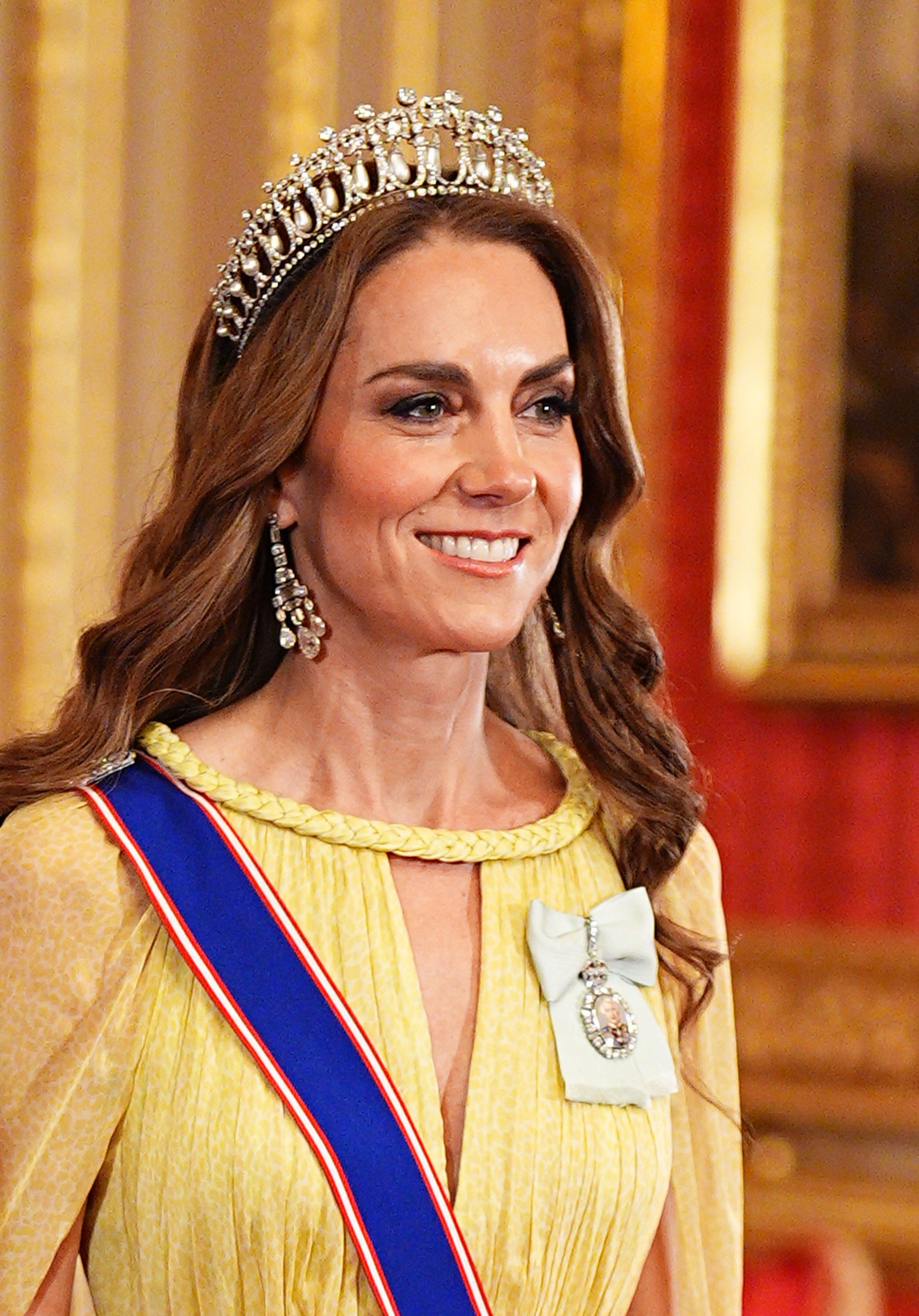 Princess Kate wearing a yellow dress and tiara