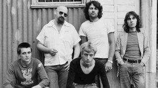 Ian Gillan’s Gillan band posing for a photograph outside a shed in 1978