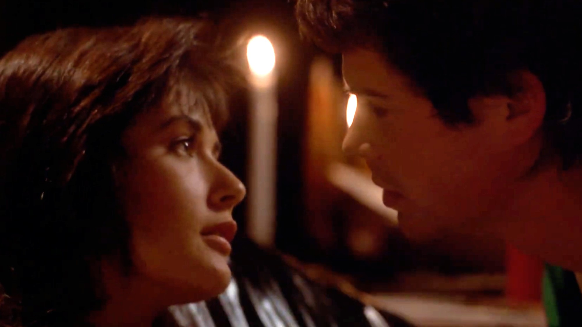 Demi Moore and Rob Lowe about to kiss in About Last Night