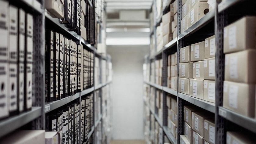 Shelves filled with folders of paper.