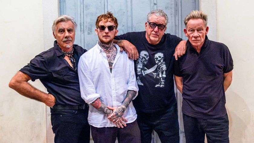 Sex Pistols with Frank Carter standing in front of a door