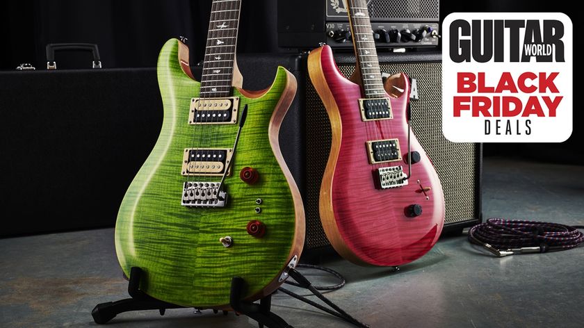 Two PRS SE Custom 24 guitars next to one another on stands