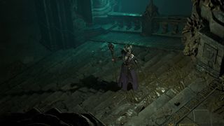 Diablo 4 Rusted key - a female wizard stands on stone stairs inside of the Belfry Zakara dungeon