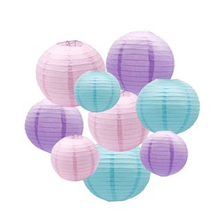 A cluster of nine pink, purple, and blue ridged circular paper lanterns