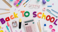 Letters that spell 'back to school' with pencils, glue, and other school supplies