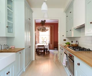 A light blue and wood galley kitchen