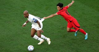 Andre Ayew of Ghana controls the ball against Inbeom Hwang of Korea Republic during the FIFA World Cup Qatar 2022 Group H match between Korea Republic and Ghana at Education City Stadium on November 28, 2022 in Al Rayyan, Qatar.