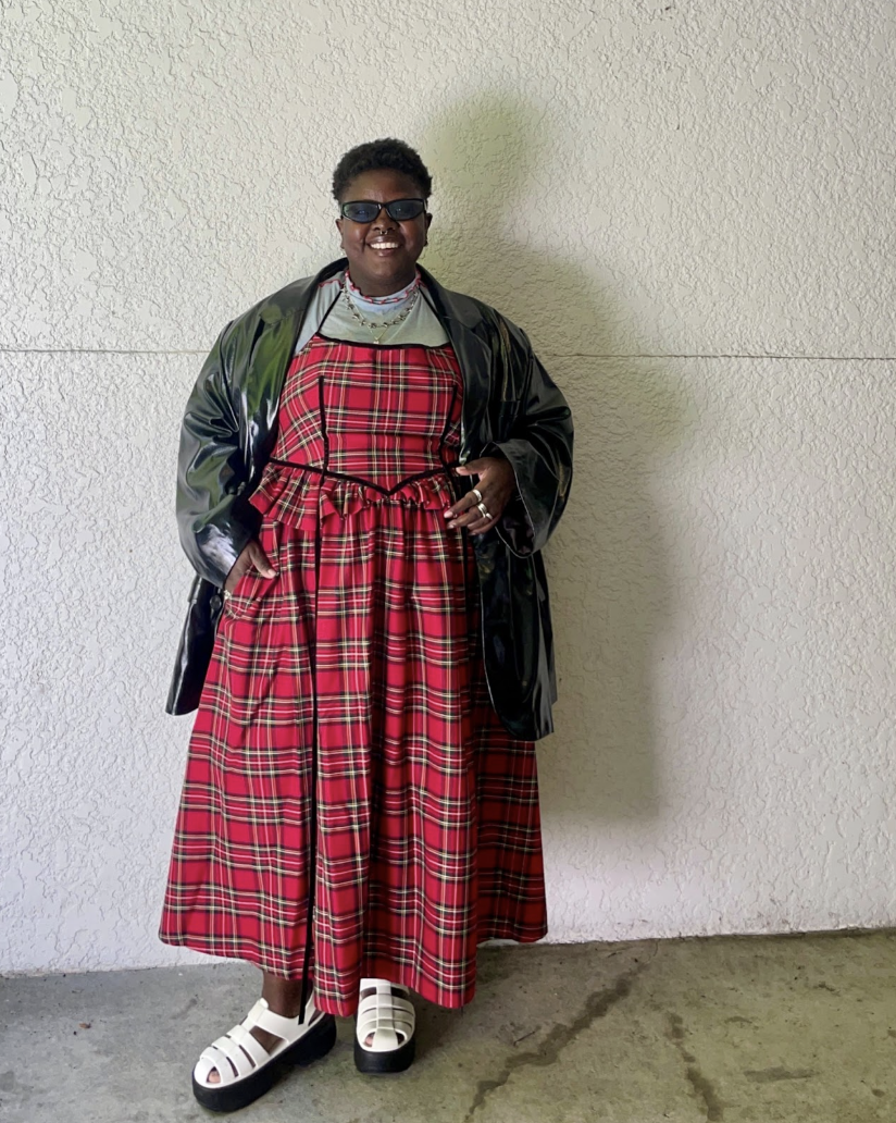 Lydia Okello wearing a plaid dress and leather dress