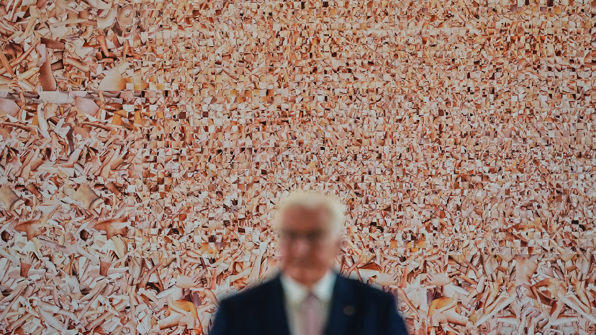 German President Frank-Walter Steinmeier speaks in front of the artwork "Hard String" by Monica Bonvicini during an exhibition preview at Bellevue Palace in Berlin, Germany
