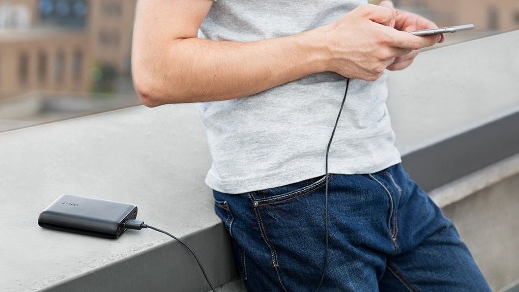 Man holding phone and power bank