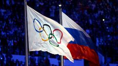 The Olympic flag and Russian flag are raised at the 2014 Sochi Winter Olympics closing ceremony 