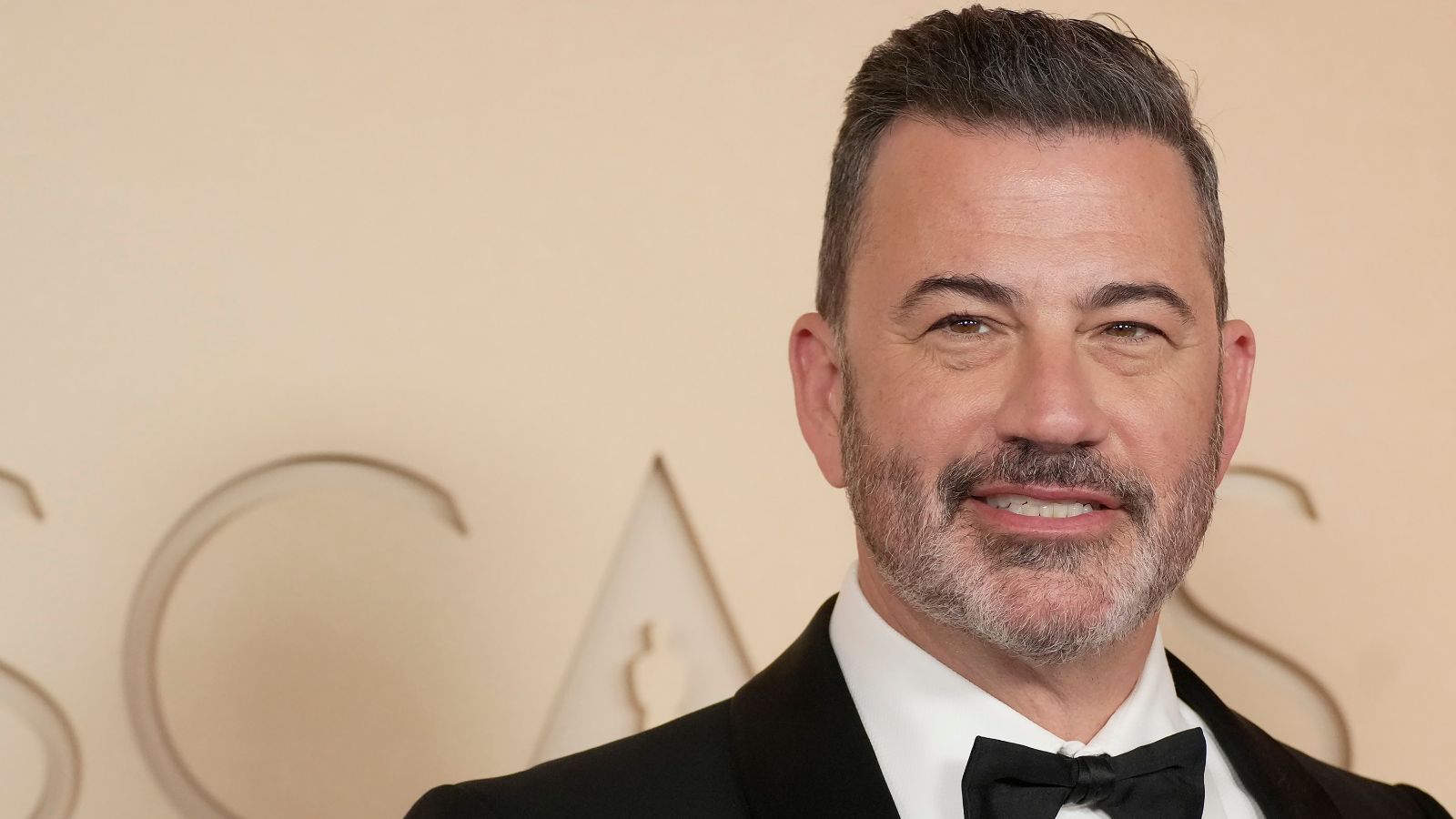 jimmy kimmel on a beige background